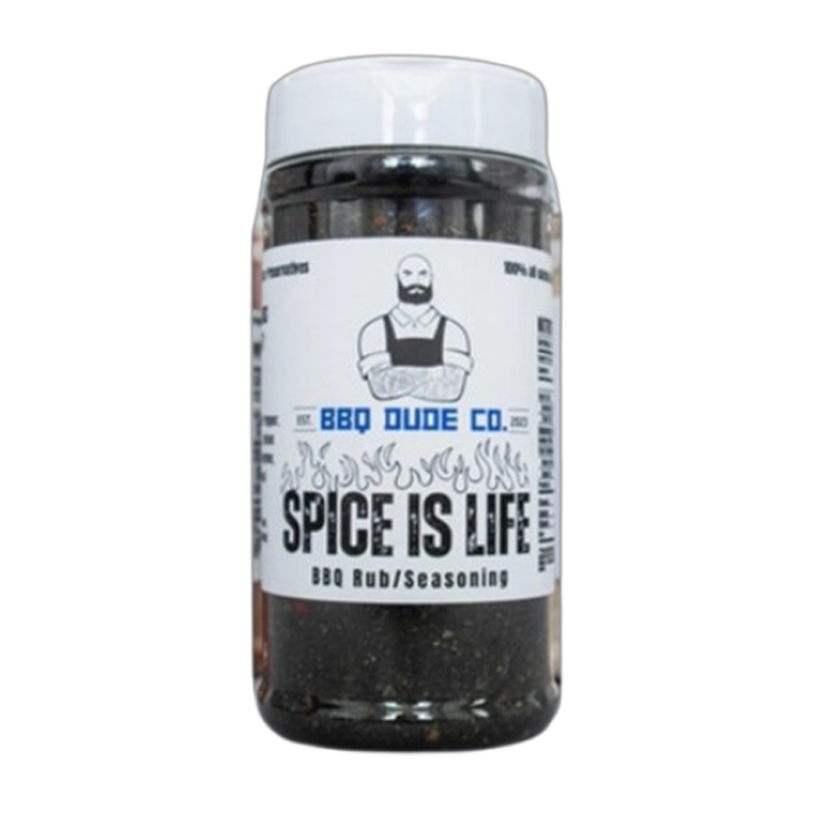 BBQ Dude Spice Is Life Seasoning bottle beside grilled chicken and chili peppers.