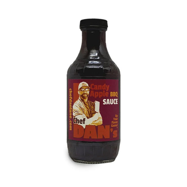Chef Dan’s Candy Apple BBQ Sauce bottle beside glazed ribs and sliced apples.
