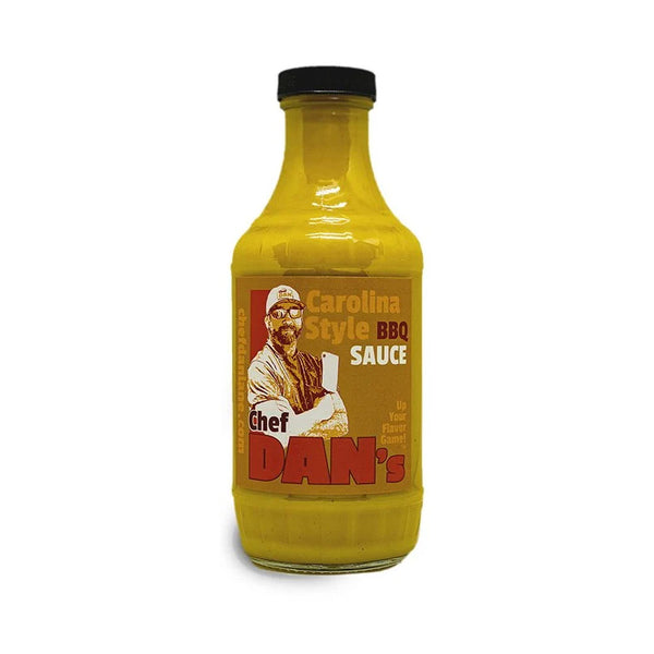 Chef Dan’s Carolina BBQ Sauce bottle beside pulled pork sandwich and slaw.